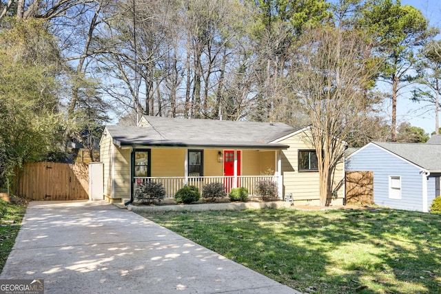 view of front of home featuring covered porch, a gate, concrete driveway, and a front yard