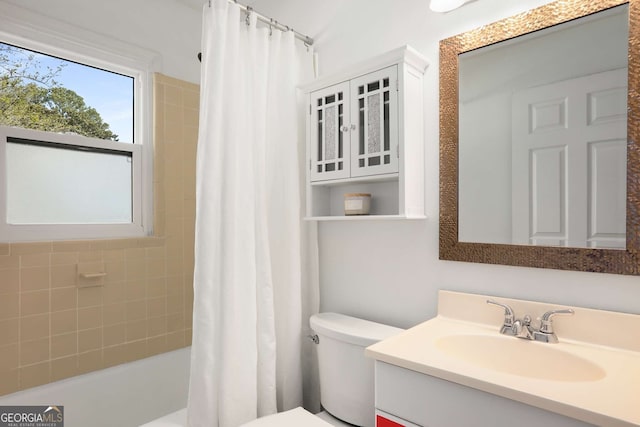 bathroom featuring shower / tub combo, vanity, and toilet