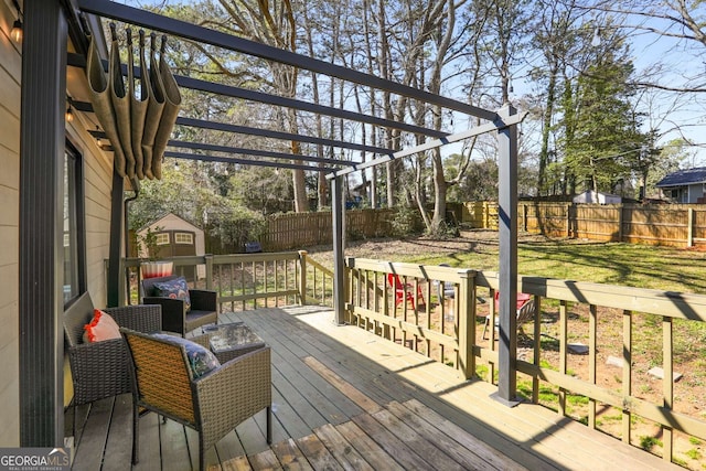 wooden terrace with a fenced backyard