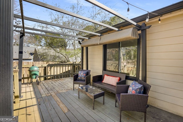 wooden terrace featuring fence, outdoor lounge area, and a pergola