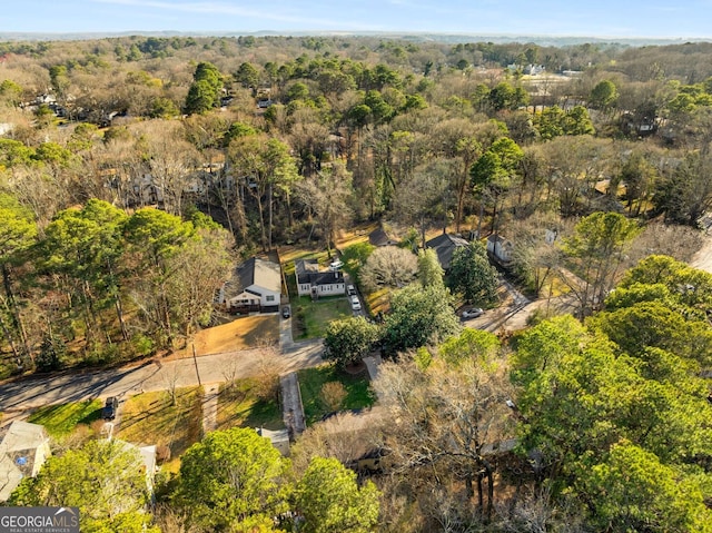 drone / aerial view with a wooded view