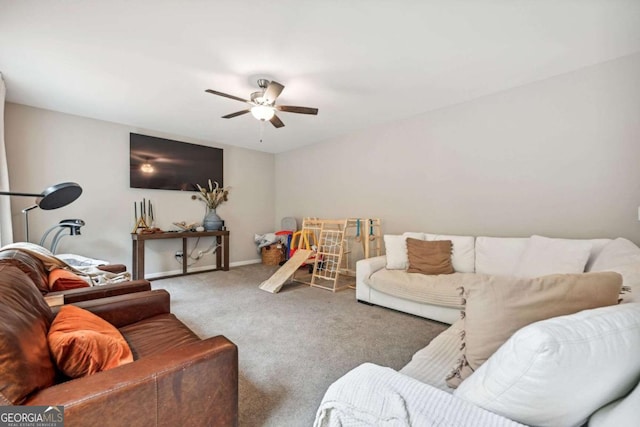 carpeted living room featuring ceiling fan and baseboards