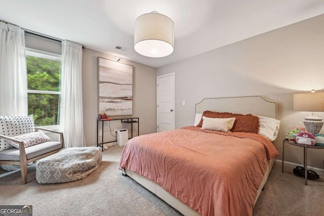 bedroom featuring carpet floors, visible vents, and baseboards