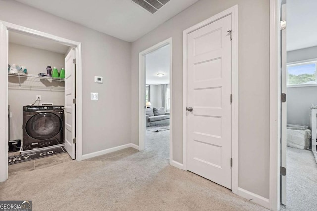 hall featuring carpet flooring, visible vents, and baseboards