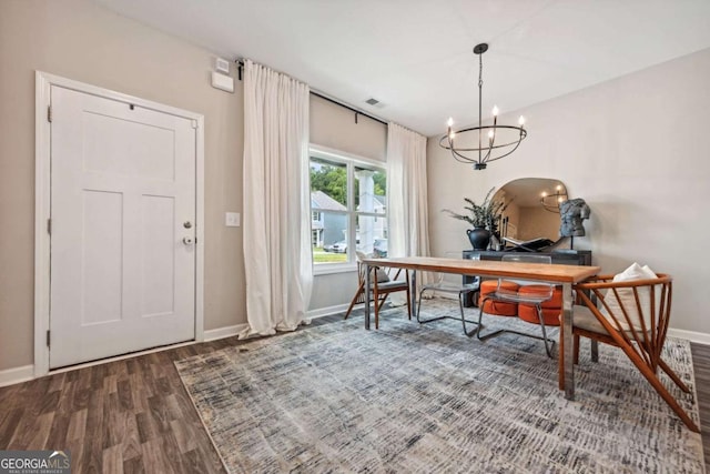 office with a notable chandelier, visible vents, baseboards, and wood finished floors