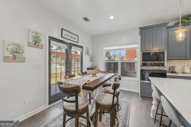 dining area with baseboards, visible vents, dark wood-style floors, french doors, and recessed lighting