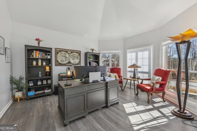 home office featuring high vaulted ceiling, baseboards, and wood finished floors