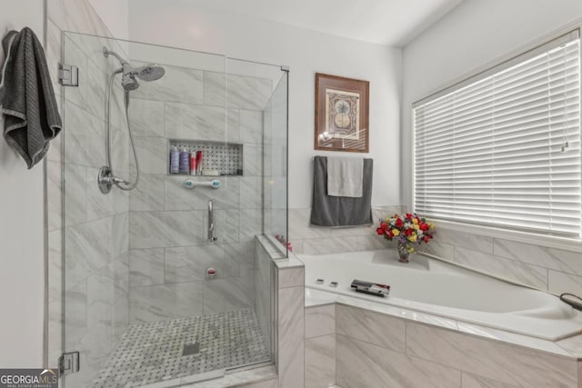 bathroom featuring a shower stall and a bath