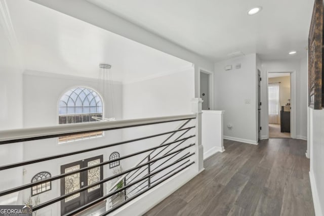 hall featuring an upstairs landing, recessed lighting, baseboards, and wood finished floors