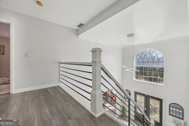 stairway with baseboards, visible vents, wood finished floors, and french doors