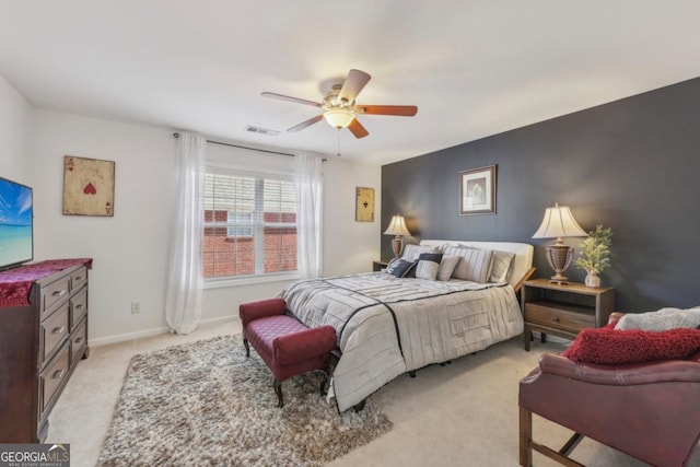 bedroom featuring baseboards, ceiling fan, visible vents, and light colored carpet