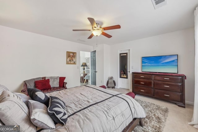 bedroom featuring light carpet, visible vents, and a ceiling fan