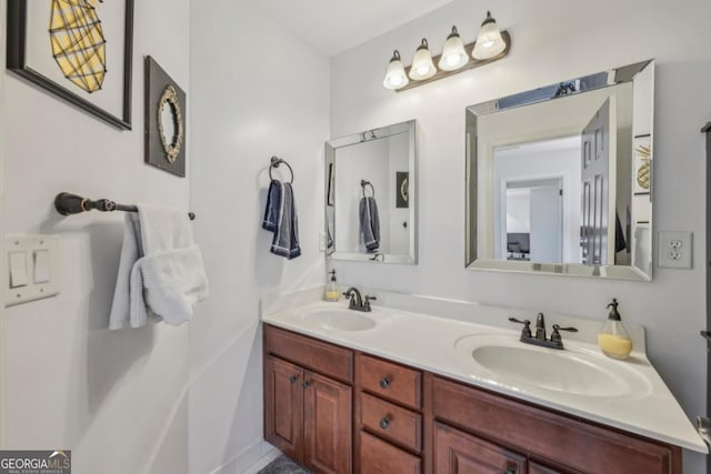 bathroom featuring a sink and double vanity