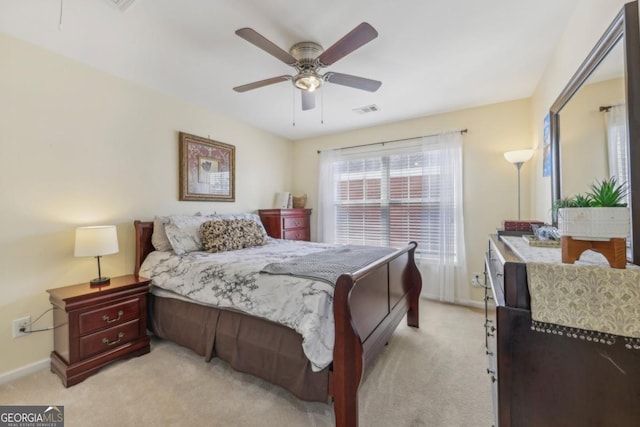 bedroom featuring baseboards, visible vents, ceiling fan, and light colored carpet