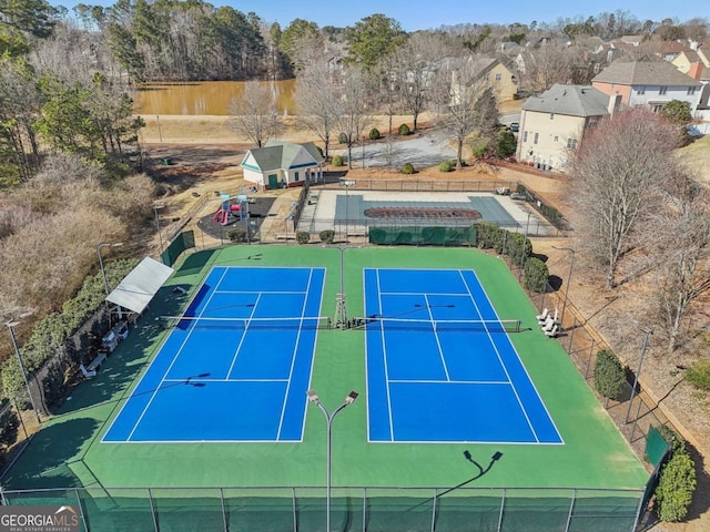 view of tennis court featuring fence