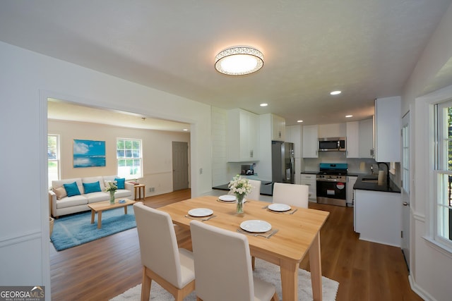 dining space with recessed lighting and dark wood-style flooring