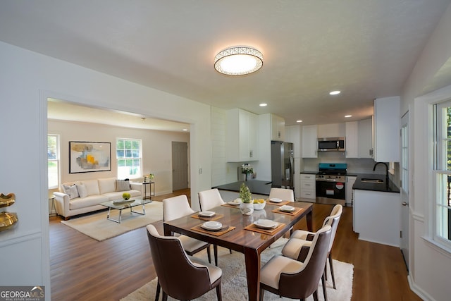 dining space with recessed lighting and dark wood finished floors