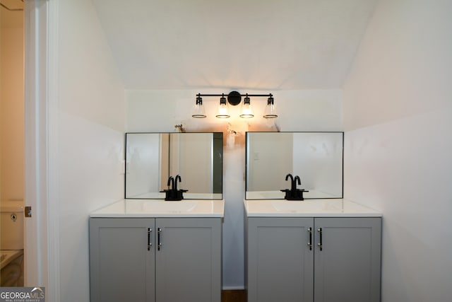bathroom featuring two vanities and a sink