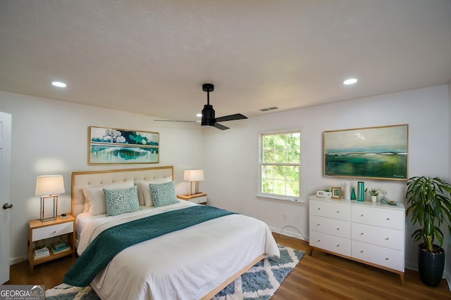 bedroom with wood finished floors, ceiling fan, visible vents, and recessed lighting