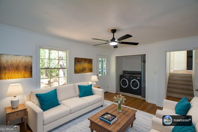 living room featuring ornamental molding, a ceiling fan, independent washer and dryer, wood finished floors, and stairs