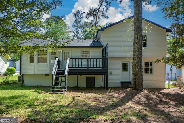 back of property featuring stairway, entry steps, a yard, a deck, and fence