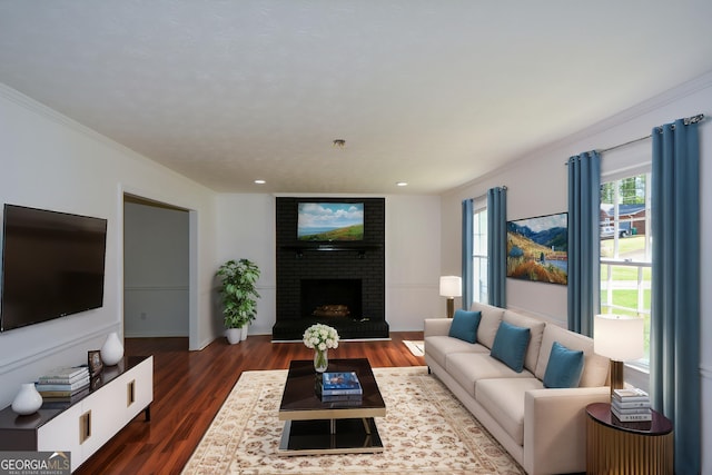 living area with recessed lighting, a fireplace, ornamental molding, and wood finished floors