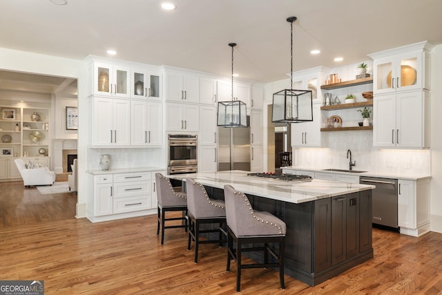 kitchen featuring a sink, open shelves, appliances with stainless steel finishes, and white cabinets