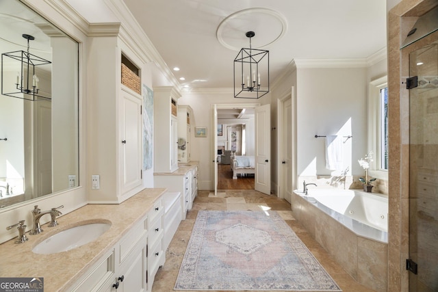 ensuite bathroom with a jetted tub, ornamental molding, connected bathroom, and a chandelier