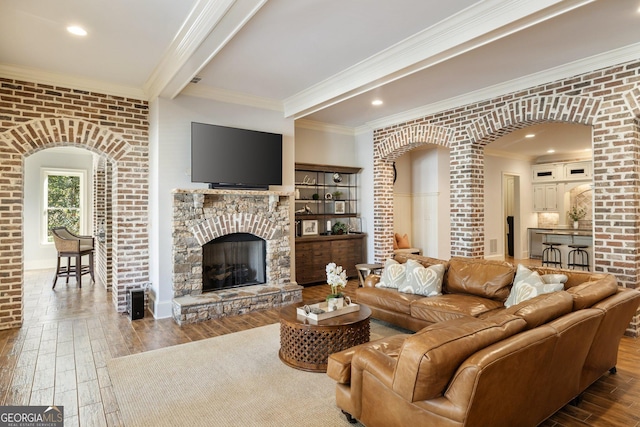 living room with brick wall, arched walkways, and wood-type flooring