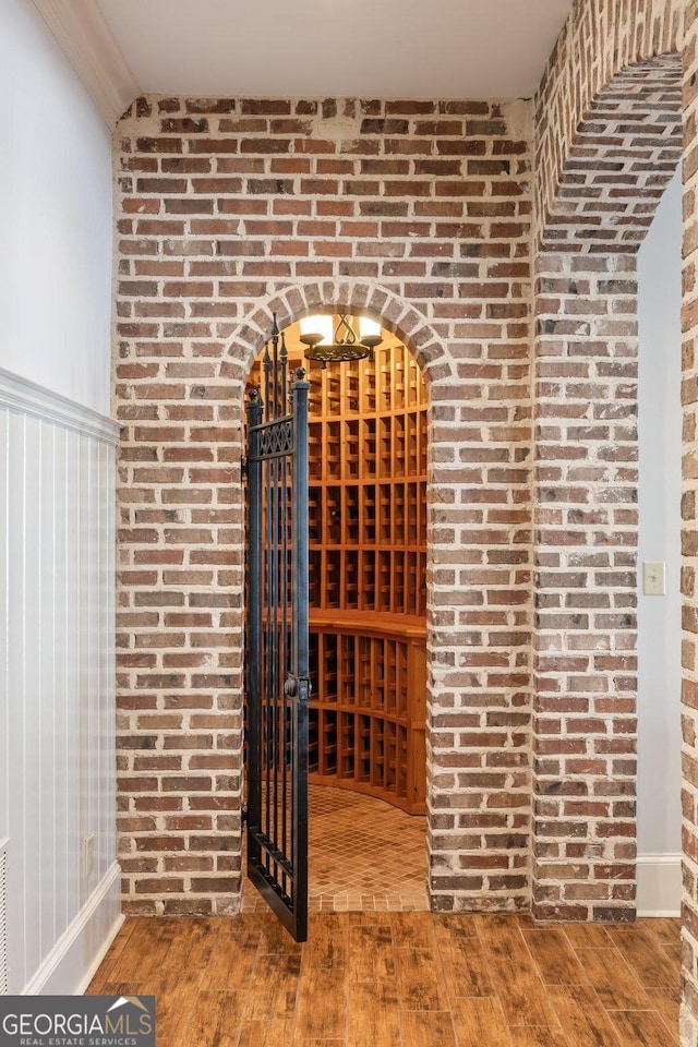 wine area with baseboards and hardwood / wood-style floors