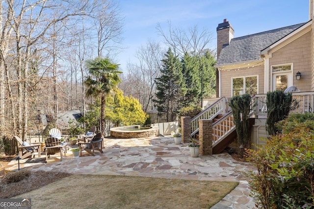 view of yard with an outdoor fire pit, stairs, and a patio