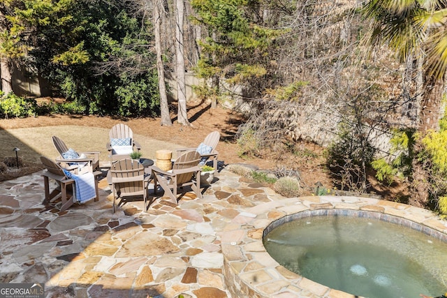 view of patio / terrace featuring an in ground hot tub