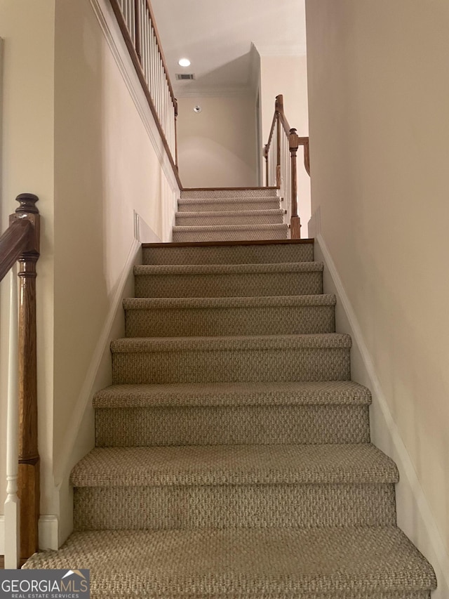 stairway featuring visible vents and recessed lighting