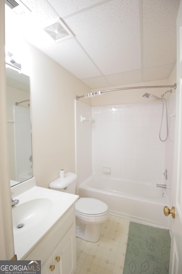 full bath with shower / washtub combination, a paneled ceiling, visible vents, toilet, and vanity