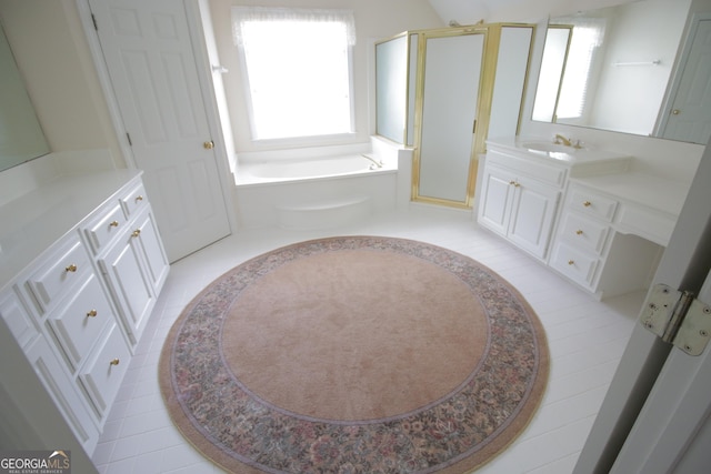 bathroom with a garden tub, vanity, and a shower stall