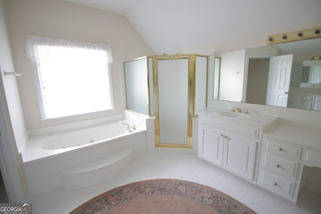 full bath featuring a garden tub, vaulted ceiling, a stall shower, and vanity