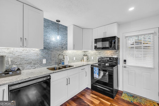 153 Coleman Heights Ln, Rabun Gap, GA 30568 - kitchen with black appliances, white cabinetry, decorative backsplash, and light stone counters