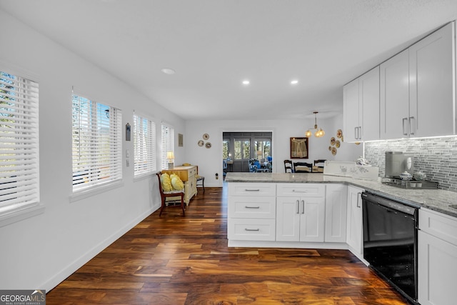 kitchen featuring tasteful backsplash, white cabinets, dishwasher, a peninsula, and light stone countertops