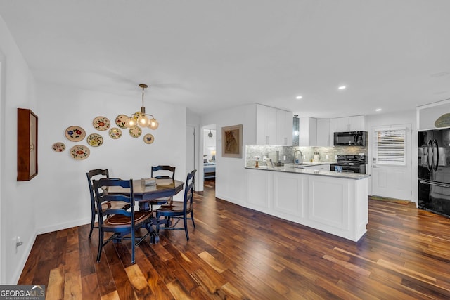 dining room with baseboards, a chandelier, dark wood finished floors, and recessed lighting