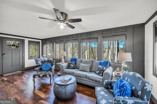 sunroom / solarium featuring a healthy amount of sunlight and a ceiling fan