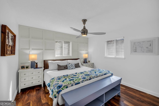 bedroom with ceiling fan, baseboards, and wood finished floors