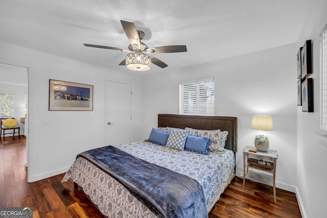 bedroom featuring ceiling fan, baseboards, and wood finished floors