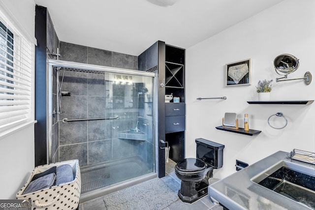 full bath featuring a shower stall, toilet, and tile patterned floors