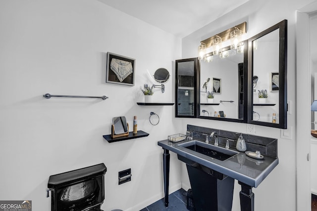 bathroom with a sink and baseboards