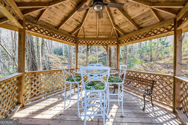 153 Coleman Heights Ln, Rabun Gap, GA 30568 - wooden terrace with a gazebo, outdoor dining space, a ceiling fan, and view of scattered trees