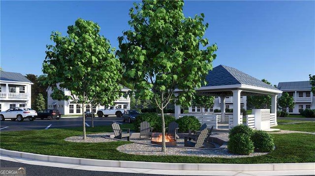 view of community with uncovered parking, an outdoor fire pit, a lawn, and a gazebo