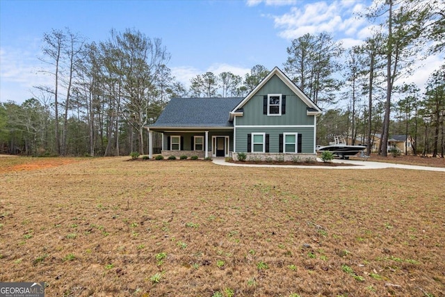 craftsman inspired home featuring board and batten siding, a front yard, and covered porch