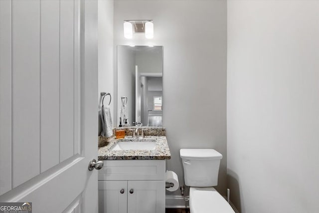 bathroom with toilet and vanity