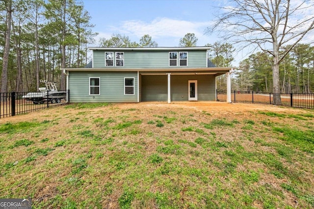 back of property with a lawn and a fenced backyard