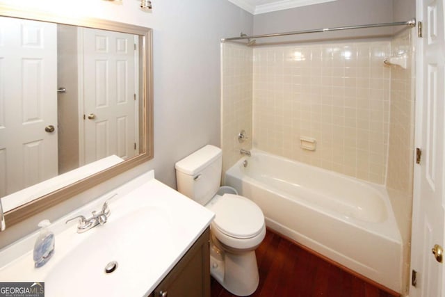 bathroom with toilet, vanity, crown molding, and  shower combination